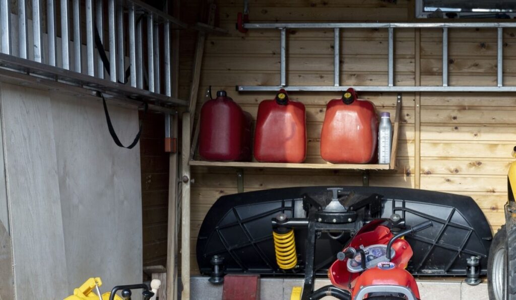 Inside view open door ATV quad bike motorcycle parking messy garage