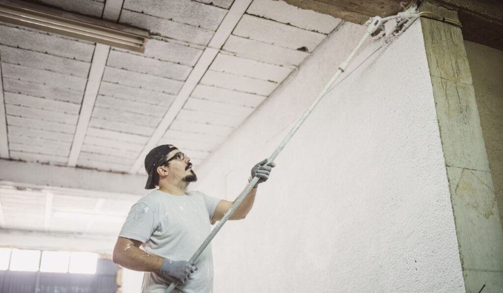 Real shot of Man painting garage