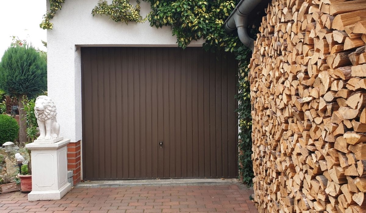 View of a pile of firewood stacked in a garage prepared for winter