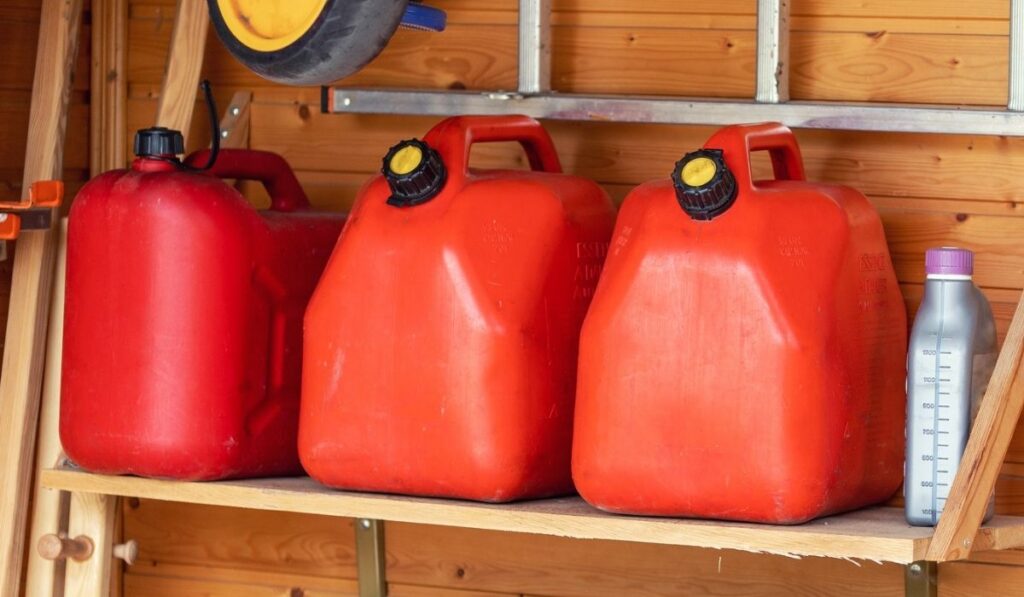 Garage corner with three red plastic fuel cans