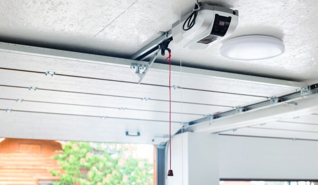 Opening door and automatic garage door opener electric engine gear mounted on ceiling with emergency cord