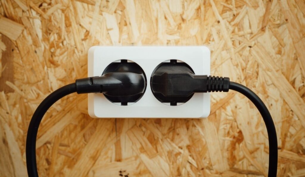 AC power plug and socket, wooden osb background