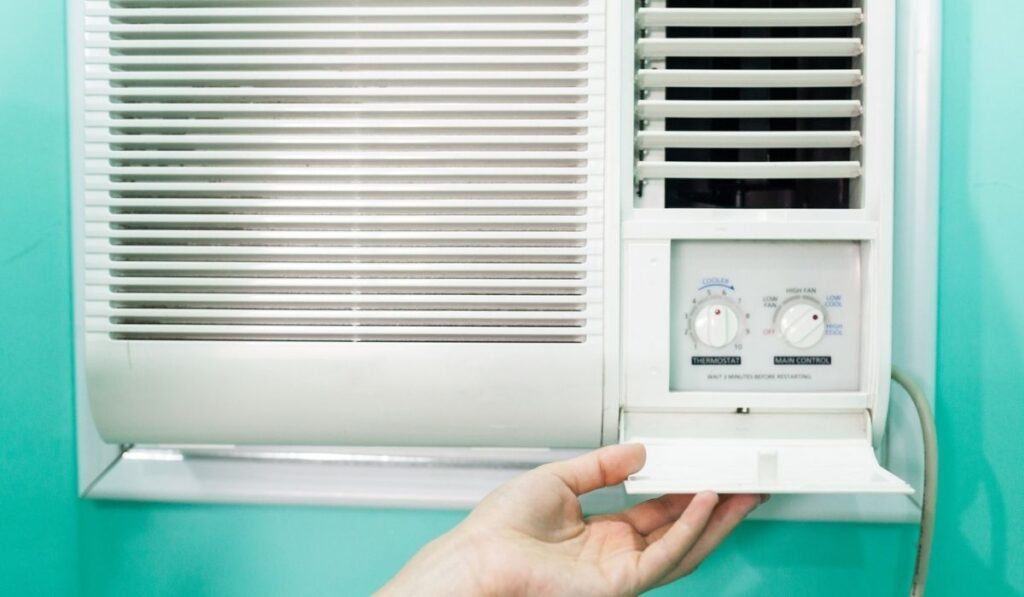 An Open panel adjustment of a small room air conditioner