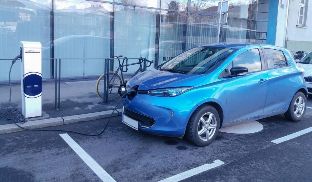 Modern electric car EV Car plugged in charging on the street station 