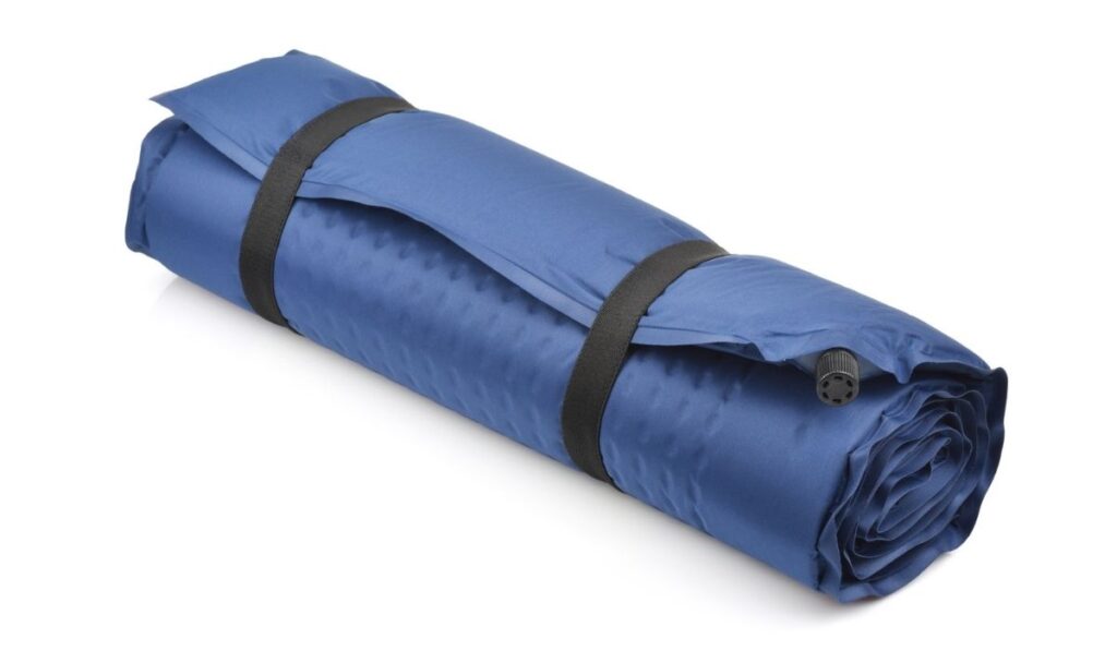 Rolled blue self-inflating camping mattress