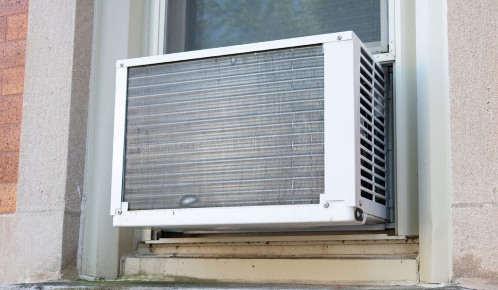 Window Air Conditioning Unit seen from Outside on a Brick Urban Building