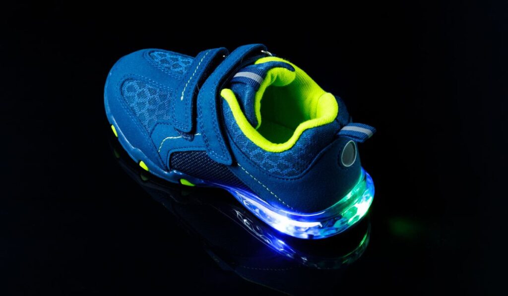 Children`s sneaker shoe with led light illumination