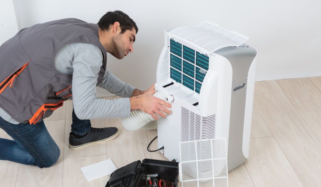 Man working on mobile air conditioning unit 