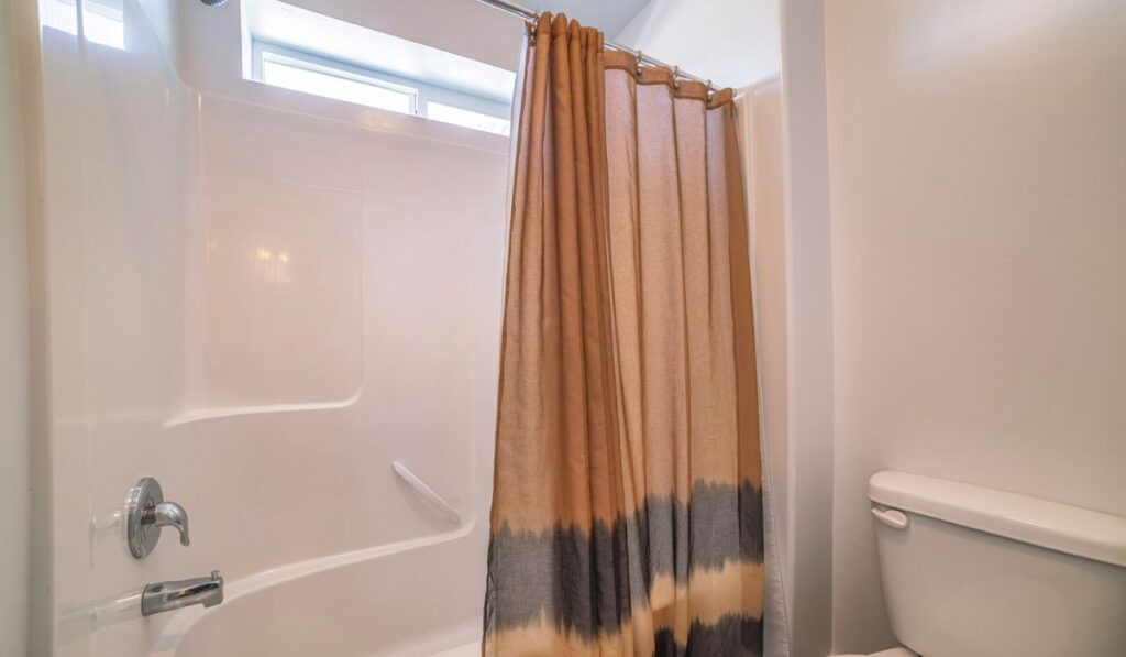 Traditional bathroom with brown shower curtain with black stripes