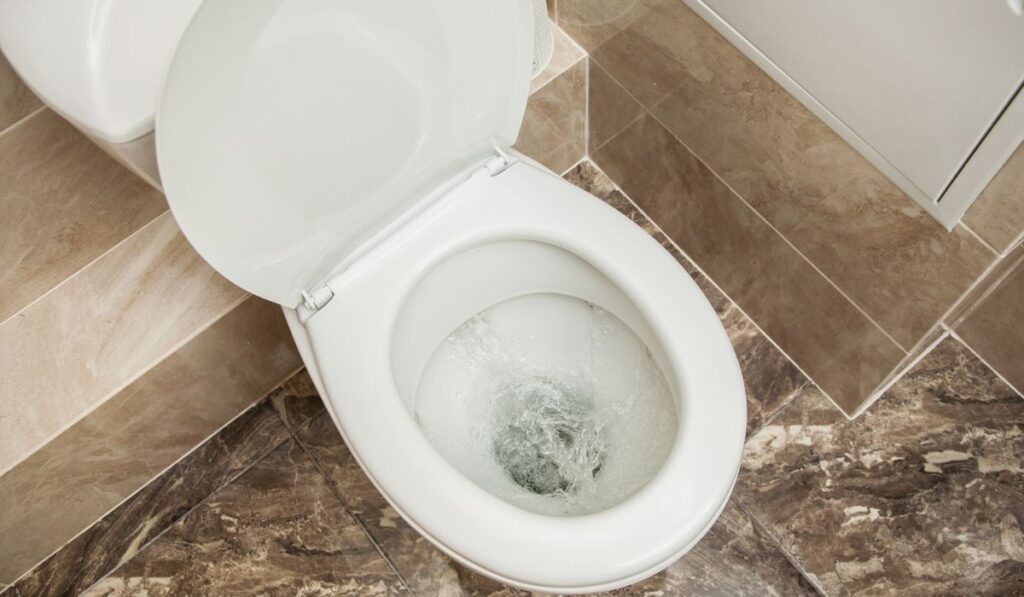 A strong whirlpool of water in the toilet 