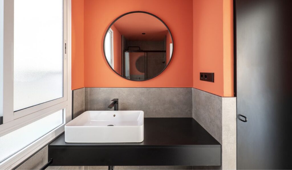 Bathroom with a white porcelain sink on a black wooden countertop