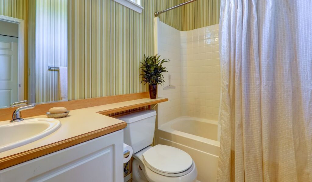 Simple bathroom interior with green wallpaper