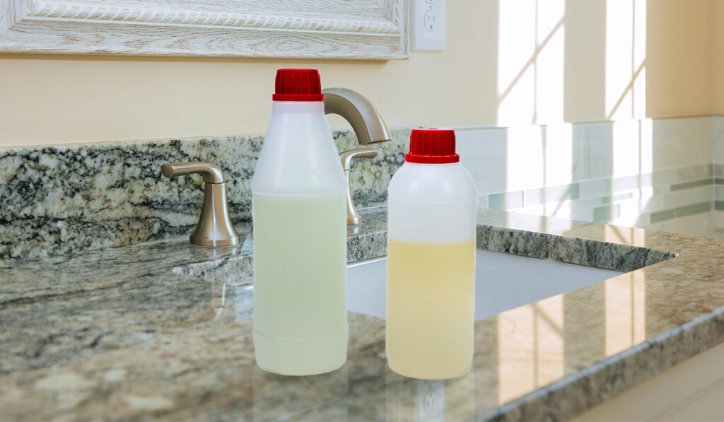 Two bottles of epoxy on a bathroom sink